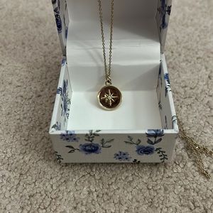 Gold tone compass necklace